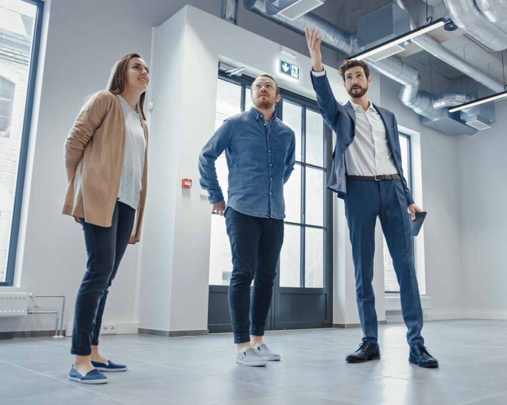 A mortgage broker showing a client around a commercial property