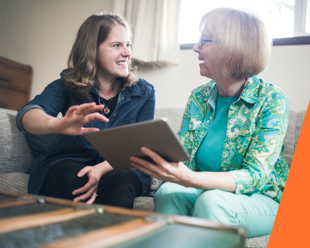 A mum and her daughter looking at houses on an Ipad and discussing how help from family buying a house could work