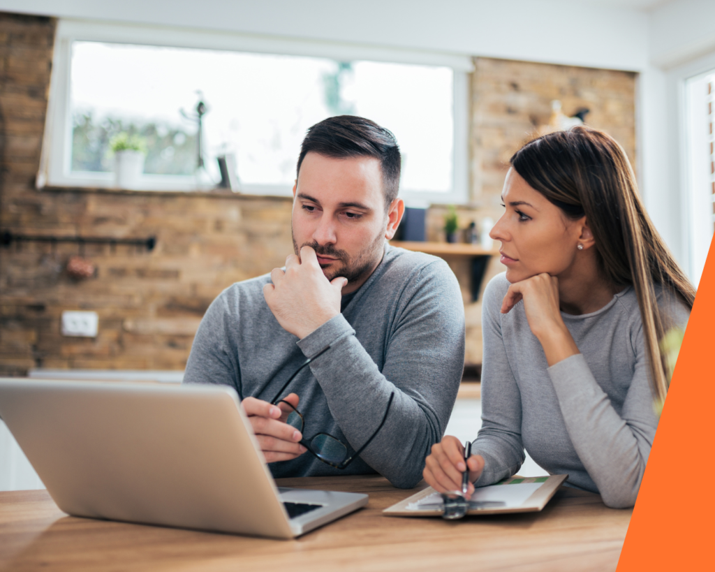 Couple reviewing interest‑only mortgage criteria and lender requirements at a kitchen table